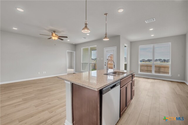 kitchen with sink, ceiling fan, decorative light fixtures, stainless steel dishwasher, and light wood-type flooring