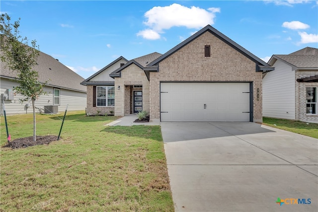 view of front of home with central AC unit, a garage, and a front lawn