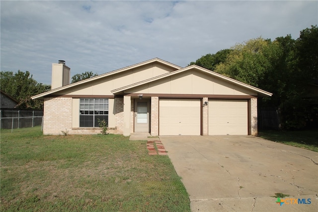 ranch-style home featuring a front lawn and a garage