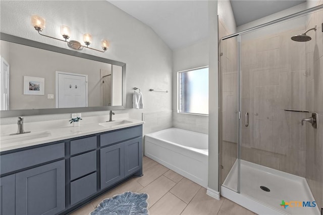 bathroom featuring vanity, lofted ceiling, independent shower and bath, and tile patterned flooring