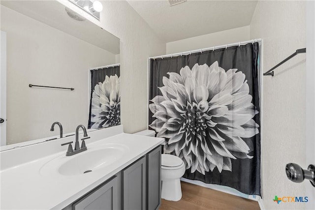 4701 Ridgehaven Dr, Killeen, TX 76543 - bathroom with wood finished floors, vanity, toilet, and curtained shower