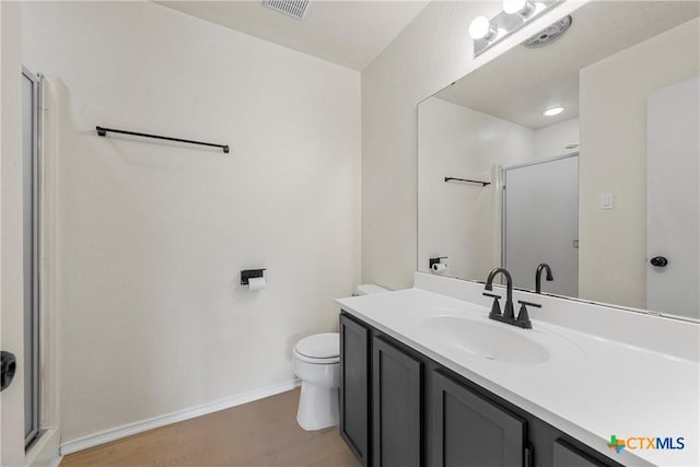 4701 Ridgehaven Dr, Killeen, TX 76543 - full bathroom with a shower stall, wood finished floors, toilet, vanity, and baseboards