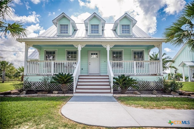 24135 State Highway 172, Port Lavaca, TX 77979 - view of front of property featuring a porch, a metal roof, and a front lawn