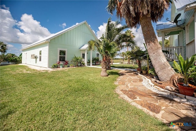 24135 State Highway 172, Port Lavaca, TX 77979 - view of front facade with board and batten siding and a front lawn