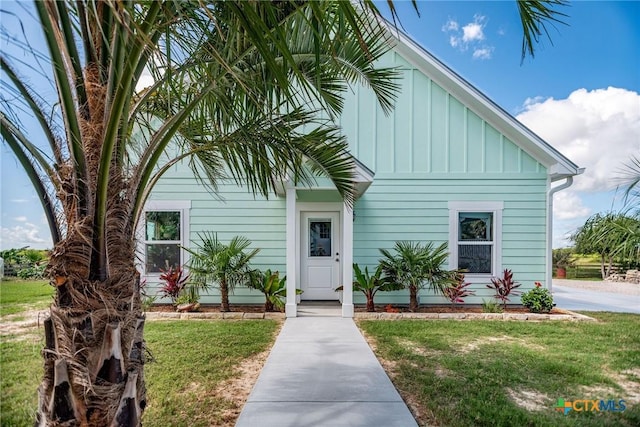 24135 State Highway 172, Port Lavaca, TX 77979 - view of front of home with board and batten siding and a front lawn