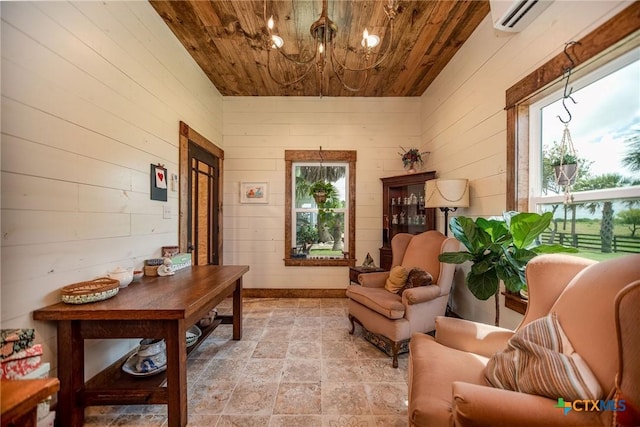 24135 State Highway 172, Port Lavaca, TX 77979 - sitting room featuring wood ceiling, wooden walls, a chandelier, light stone finish floors, and an AC wall unit