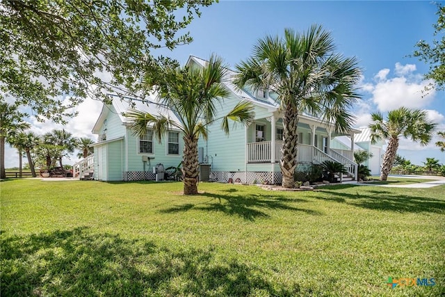 24135 State Highway 172, Port Lavaca, TX 77979 - view of property exterior featuring a porch, a yard, and stairway
