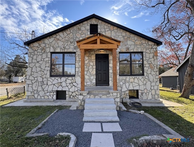 bungalow-style home with a front yard