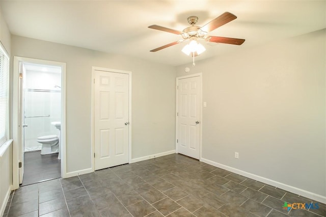 1504 Phyllis Dr, Copperas Cove, TX 76522 - unfurnished bedroom featuring baseboards, connected bathroom, ceiling fan, and dark tile patterned floors