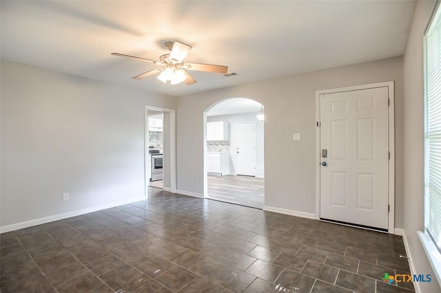 1504 Phyllis Dr, Copperas Cove, TX 76522 - foyer with arched walkways, ceiling fan, and baseboards