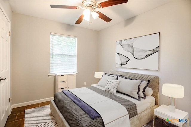 1504 Phyllis Dr, Copperas Cove, TX 76522 - bedroom with baseboards, a ceiling fan, and dark tile patterned floors