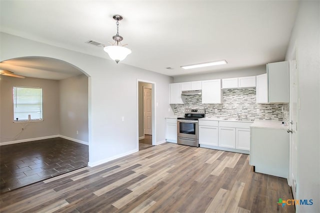 1504 Phyllis Dr, Copperas Cove, TX 76522 - kitchen with stainless steel electric stove, decorative backsplash, arched walkways, a sink, and white cabinets