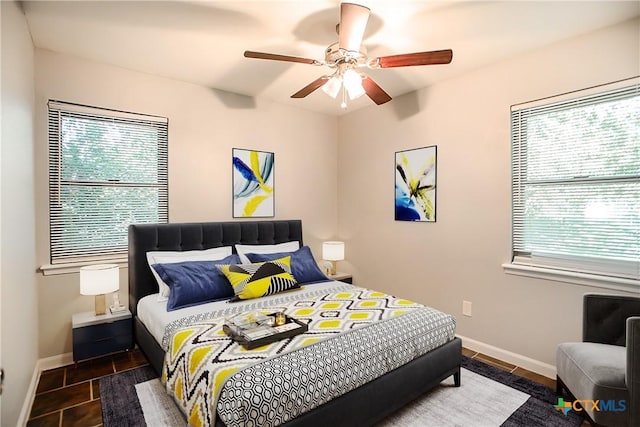 1504 Phyllis Dr, Copperas Cove, TX 76522 - bedroom with multiple windows, baseboards, and a ceiling fan