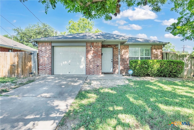 ranch-style home featuring a front lawn and a garage