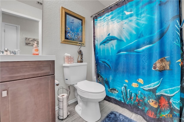 bathroom featuring hardwood / wood-style floors, vanity, and toilet