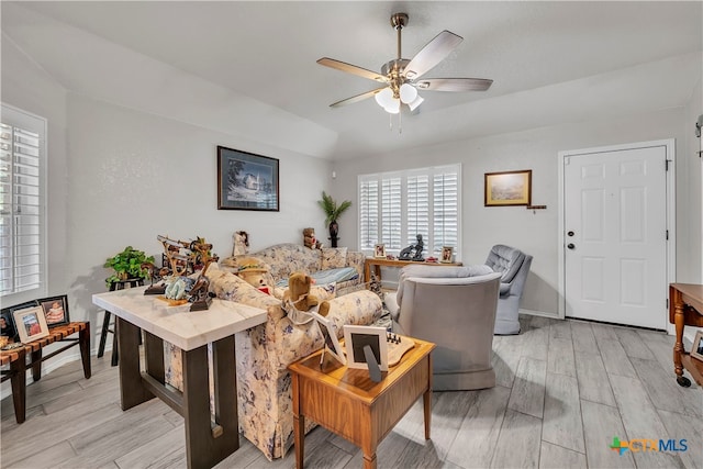 living room with ceiling fan and light hardwood / wood-style floors