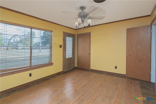 entrance foyer with wood-type flooring, ceiling fan, and crown molding