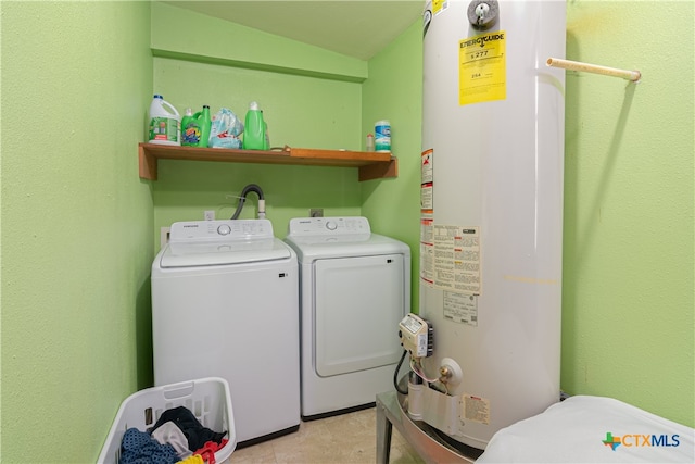 laundry area with water heater and washer and dryer