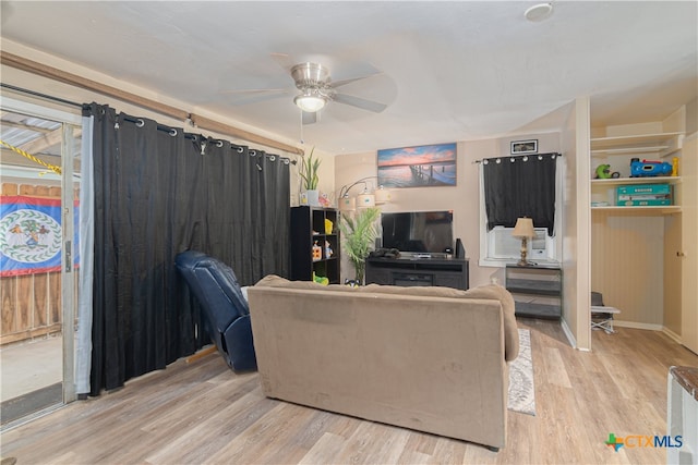 living room with ceiling fan and light wood-type flooring