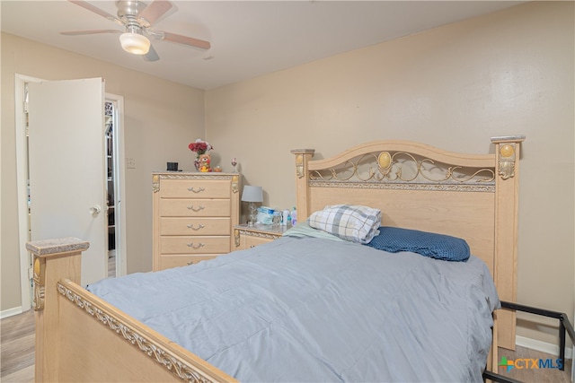 bedroom with light hardwood / wood-style floors and ceiling fan