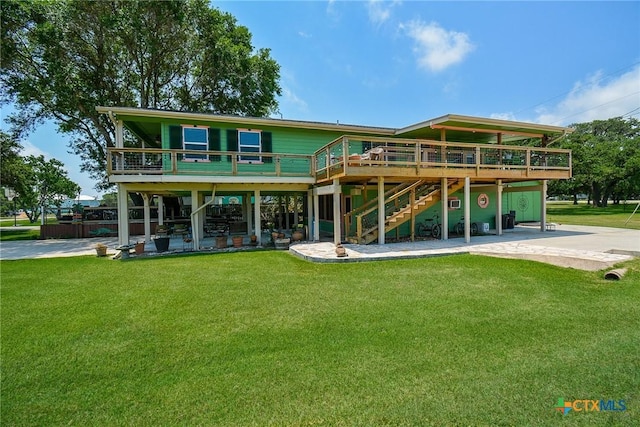 rear view of house with a deck, a yard, and a patio