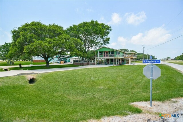 view of home's community featuring a wooden deck and a lawn