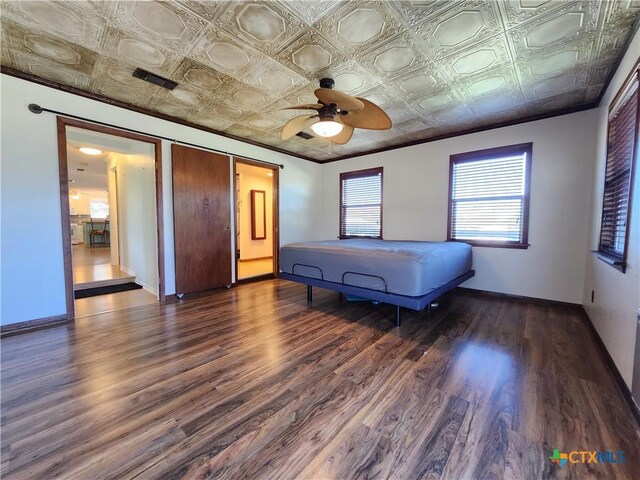 unfurnished bedroom featuring ceiling fan and dark wood-type flooring