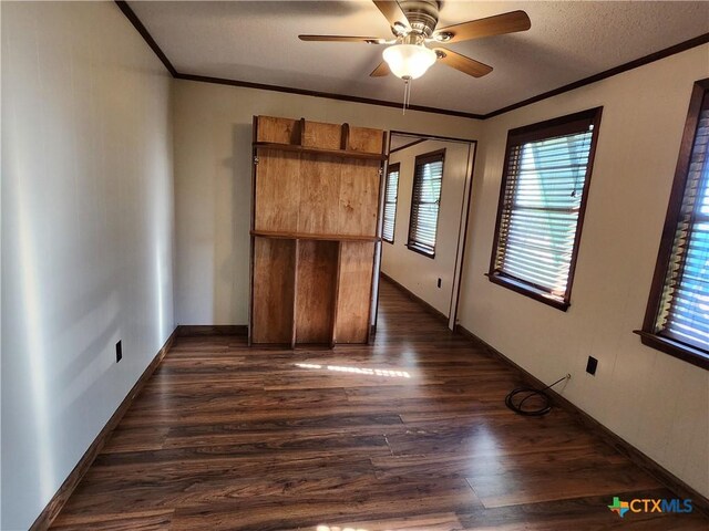 spare room featuring ceiling fan, dark hardwood / wood-style floors, and ornamental molding