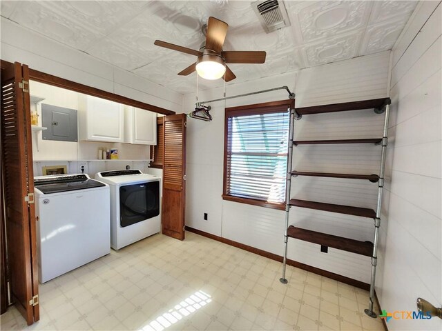 laundry room with cabinets, washing machine and dryer, electric panel, and ceiling fan