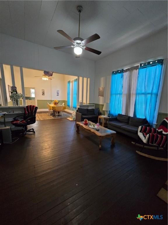 living area with ceiling fan and wood-type flooring