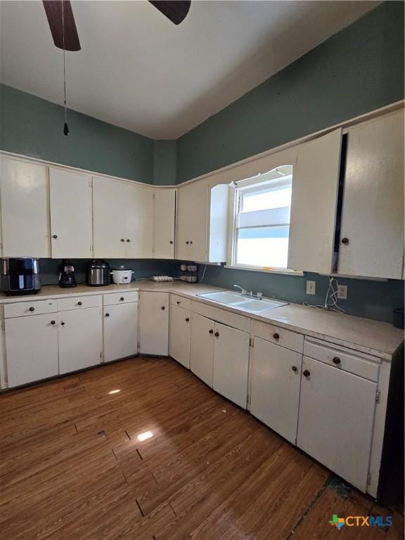 206 Dallas St, Yoakum, TX 77995 - kitchen with white cabinets, wood finished floors, light countertops, and a ceiling fan