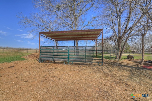 view of outdoor structure with an exterior structure, an outbuilding, and a rural view