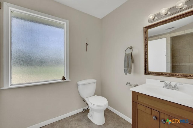 bathroom featuring toilet, visible vents, vanity, baseboards, and tile patterned floors