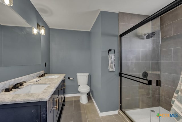 full bath with baseboards, a stall shower, a sink, and tile patterned floors