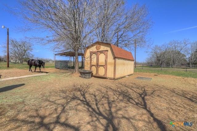 view of outdoor structure featuring an outbuilding and a rural view