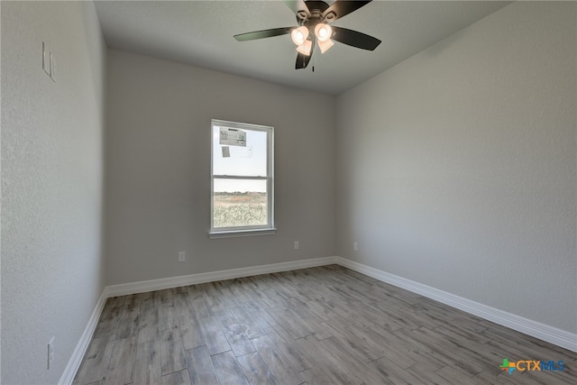 empty room featuring light hardwood / wood-style flooring and ceiling fan