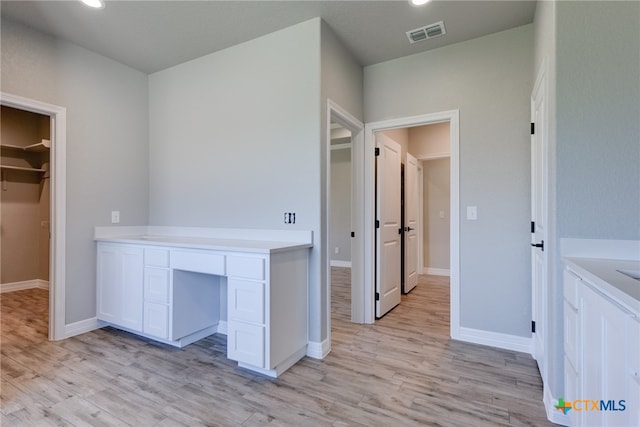 interior space featuring light wood-type flooring and built in desk