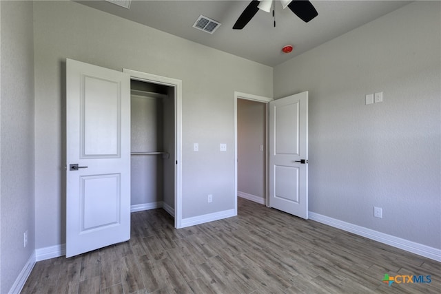 unfurnished bedroom with ceiling fan, a closet, and light hardwood / wood-style flooring