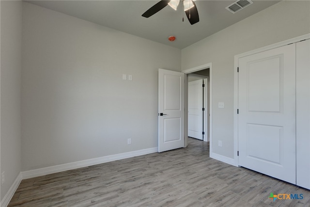 unfurnished bedroom featuring a closet, ceiling fan, and light hardwood / wood-style flooring