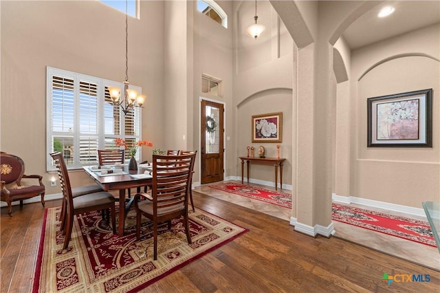 dining room featuring hardwood / wood-style floors, an inviting chandelier, and plenty of natural light