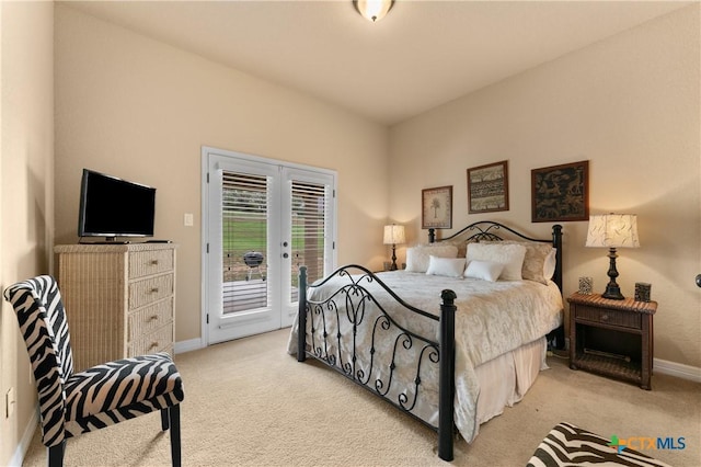 bedroom featuring baseboards, access to exterior, and light colored carpet