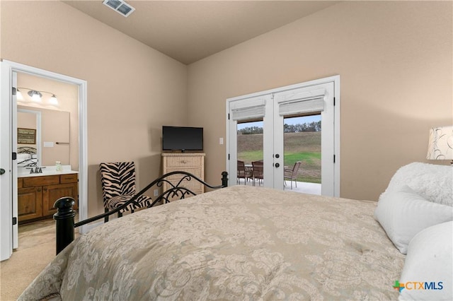bedroom with connected bathroom, access to exterior, visible vents, light carpet, and french doors