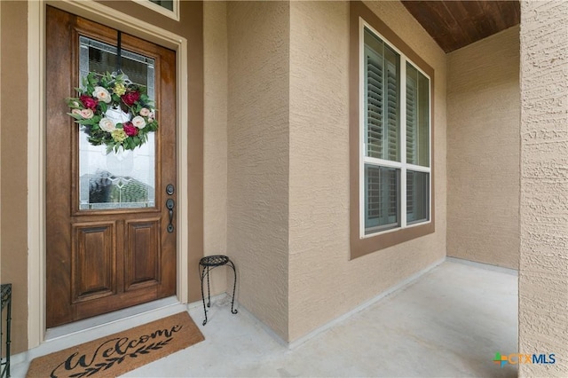 doorway to property with stucco siding