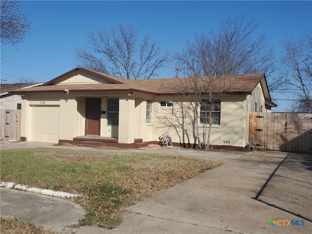 single story home featuring driveway, brick siding, an attached garage, and a gate