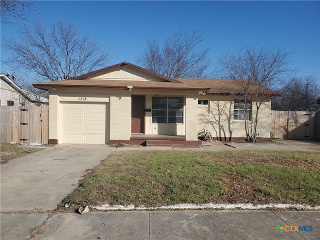 single story home with a front yard, a garage, fence, concrete driveway, and brick siding