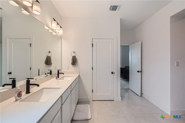 650 Texas Sage Loop, Buda, TX 78610 - full bathroom with baseboards, double vanity, and tile patterned flooring