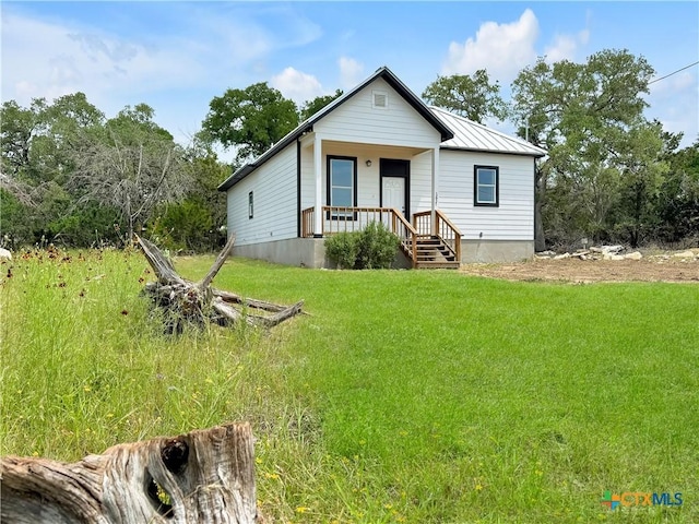 1637 Bob White Dr, Spring Branch, TX 78070 - view of front of home featuring a porch, a front lawn, metal roof, and a standing seam roof