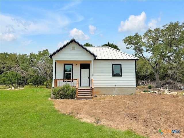 1637 Bob White Dr, Spring Branch, TX 78070 - bungalow-style home with a standing seam roof, a porch, a front lawn, and metal roof
