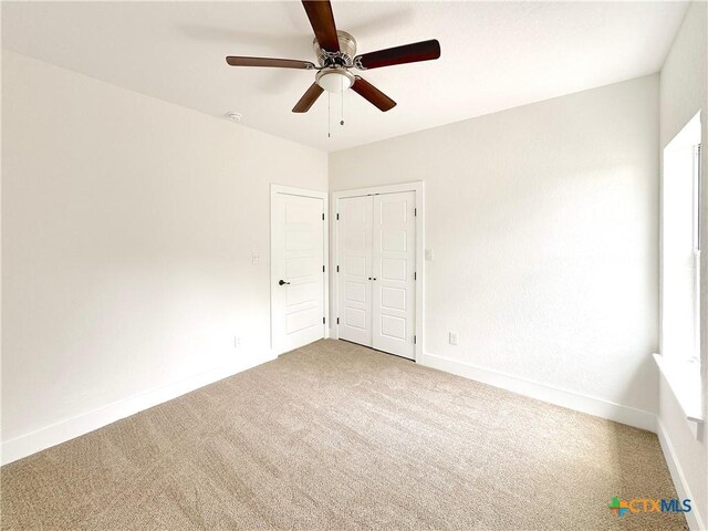 1637 Bob White Dr, Spring Branch, TX 78070 - unfurnished bedroom with carpet floors, baseboards, ceiling fan, and a closet