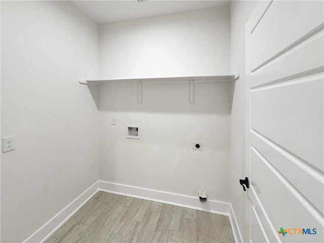 1637 Bob White Dr, Spring Branch, TX 78070 - laundry room with hookup for a washing machine, light wood finished floors, baseboards, and hookup for an electric dryer
